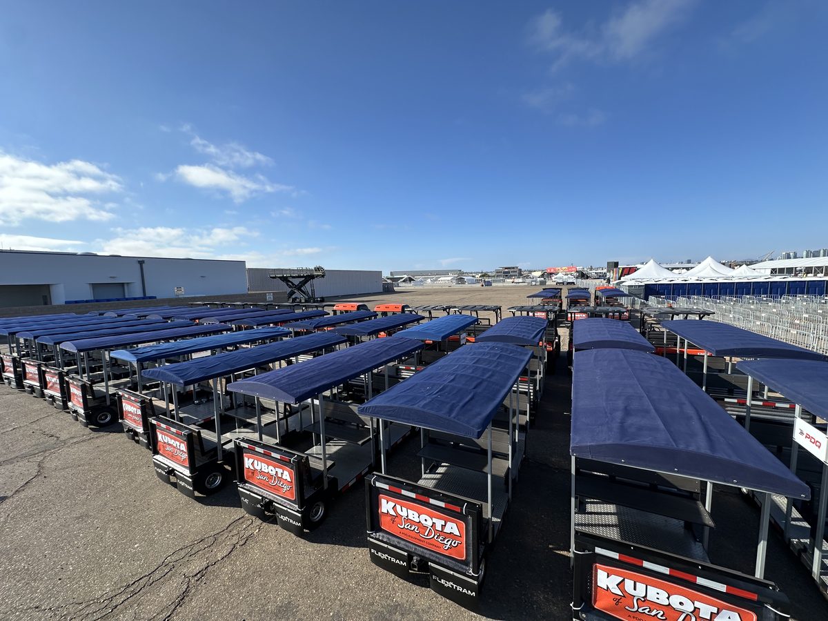 A full fleet of FlexTram vehicles staged in rows before an event