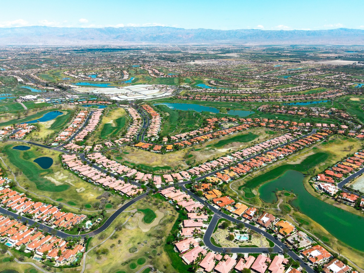 Aerial view of planned community with homes, golf courses, and amenity centers