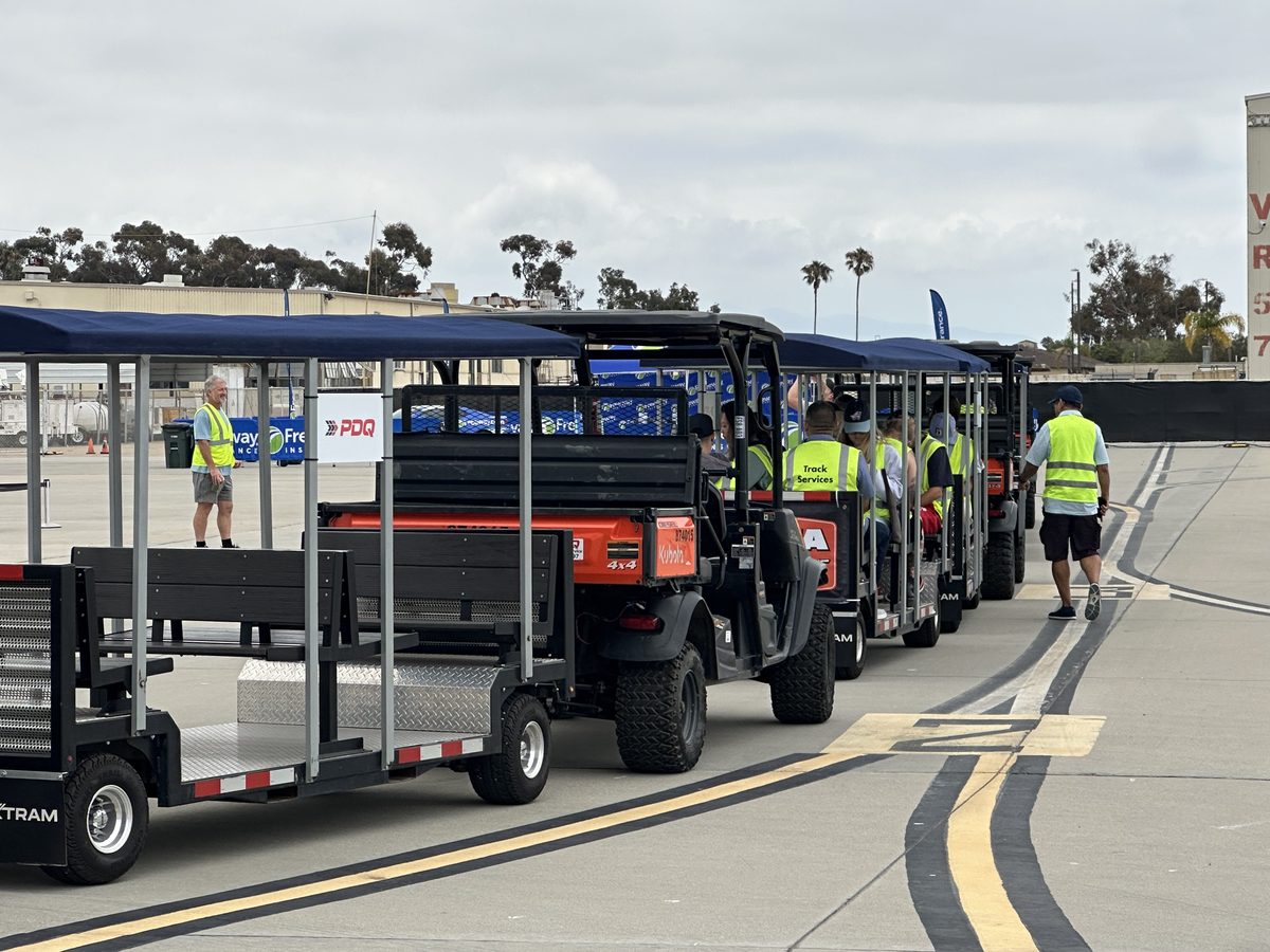 FlexTram tram loaded with track services crew on a motorsports raceway