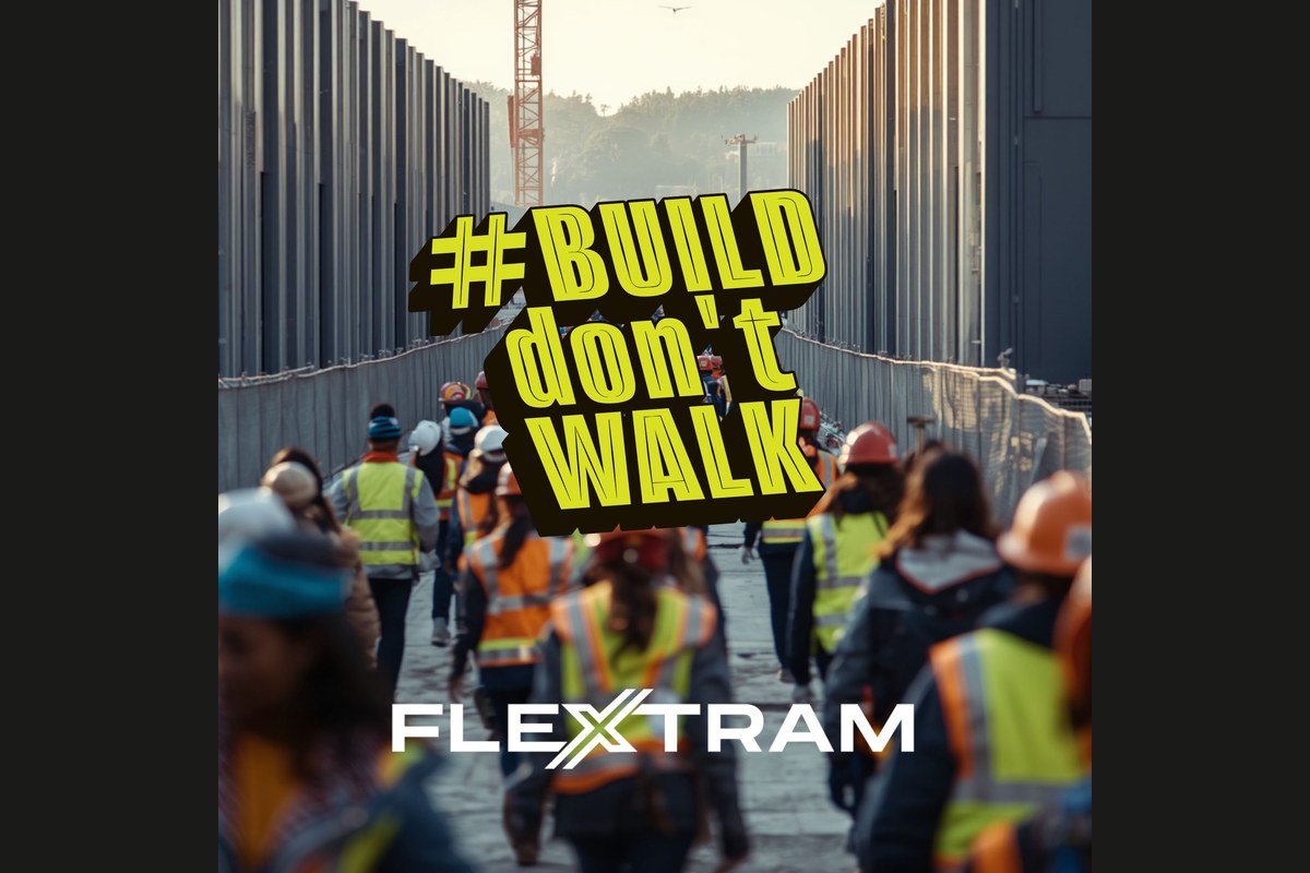 Construction workers in safety vests and hard hats walking en masse along a barricaded construction corridor with #BUILD don't WALK and FlexTram branding overlaid
