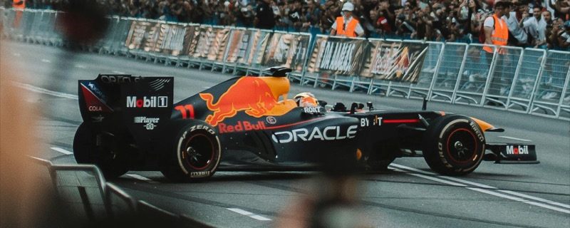 Red Bull Formula 1 car on a street circuit with a massive crowd of fans in the background