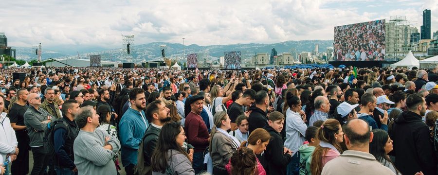 Massive crowd at an outdoor event with thousands of attendees