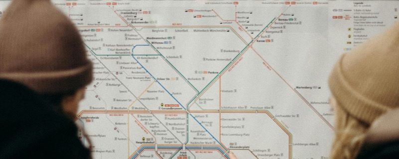 Two people studying a Berlin transit system route map