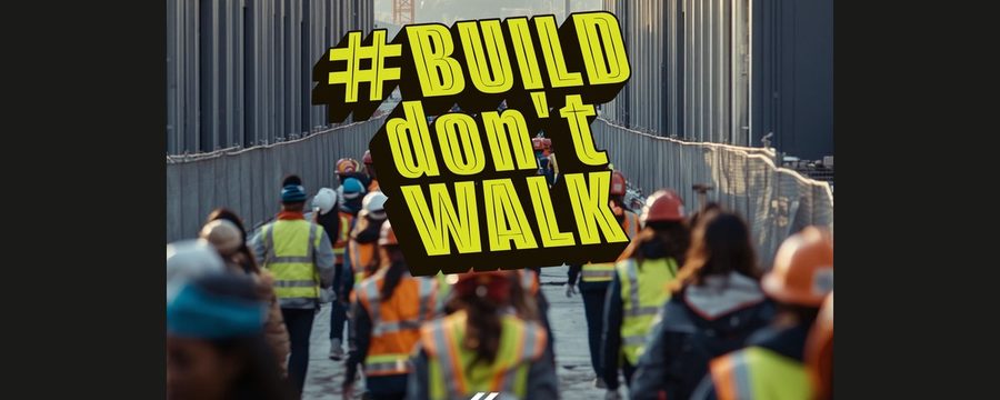 Construction workers walking across a large industrial jobsite